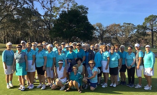 The golfers gather for a group photo on the course